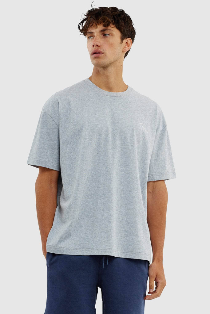Model wearing grey boxy tshirt with white ortc clothing co est 2016 logo