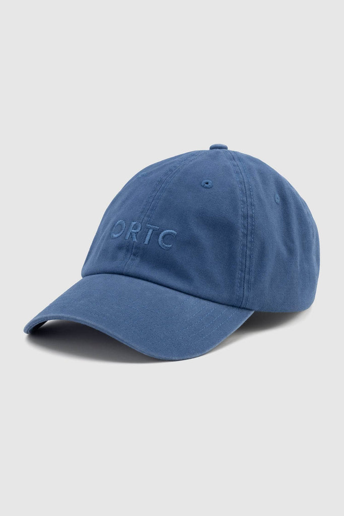 Front view of a sea blue baseball cap with an embroidered ortc logo,