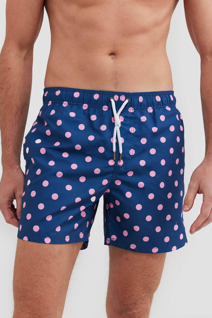 Navy board shorts with pink polka dots