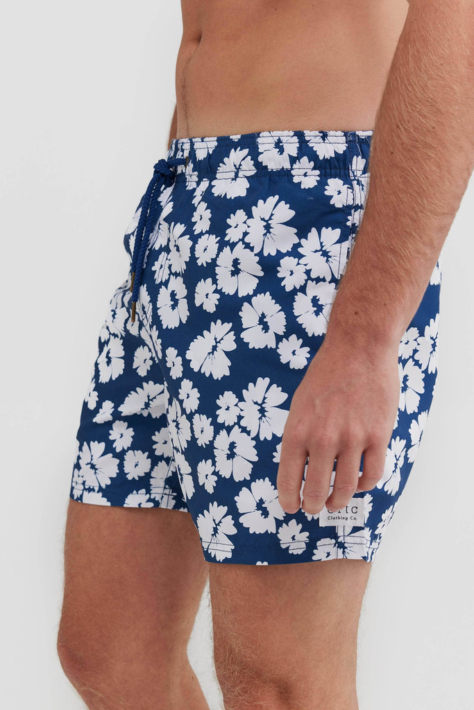 Men's board shorts.Blue with white flowers. Side profile