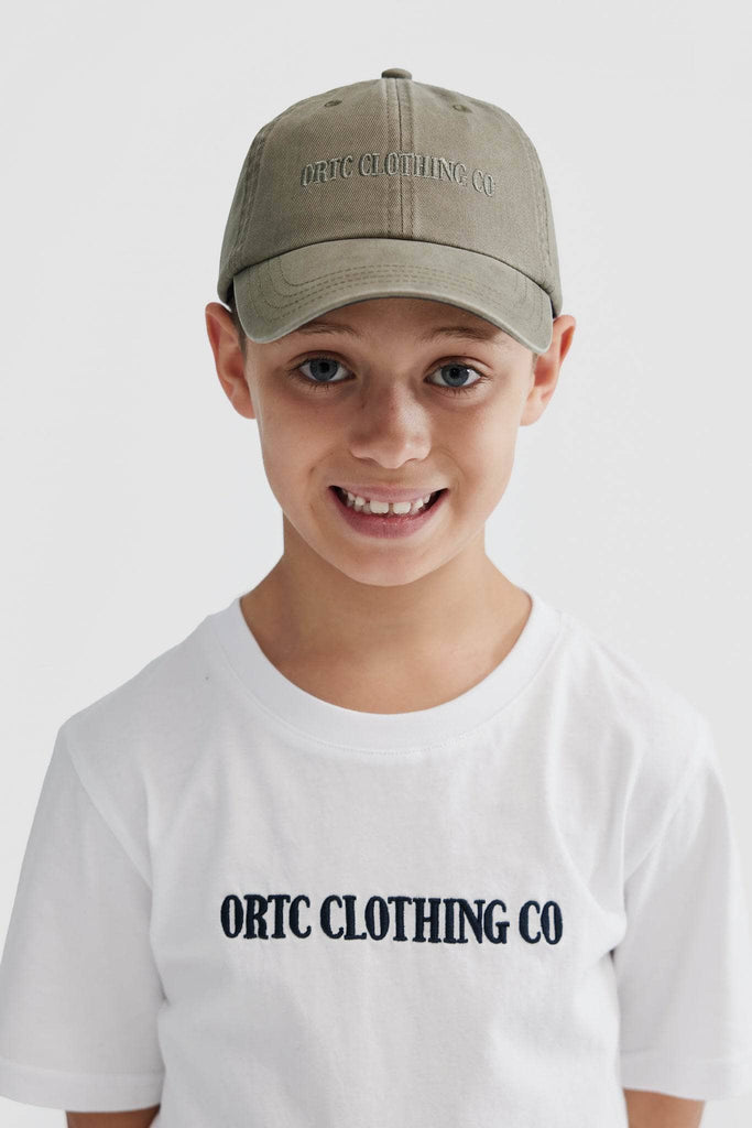 Front view of child model wearing olive green baseball cap with olive embroidered ortc clothing co
